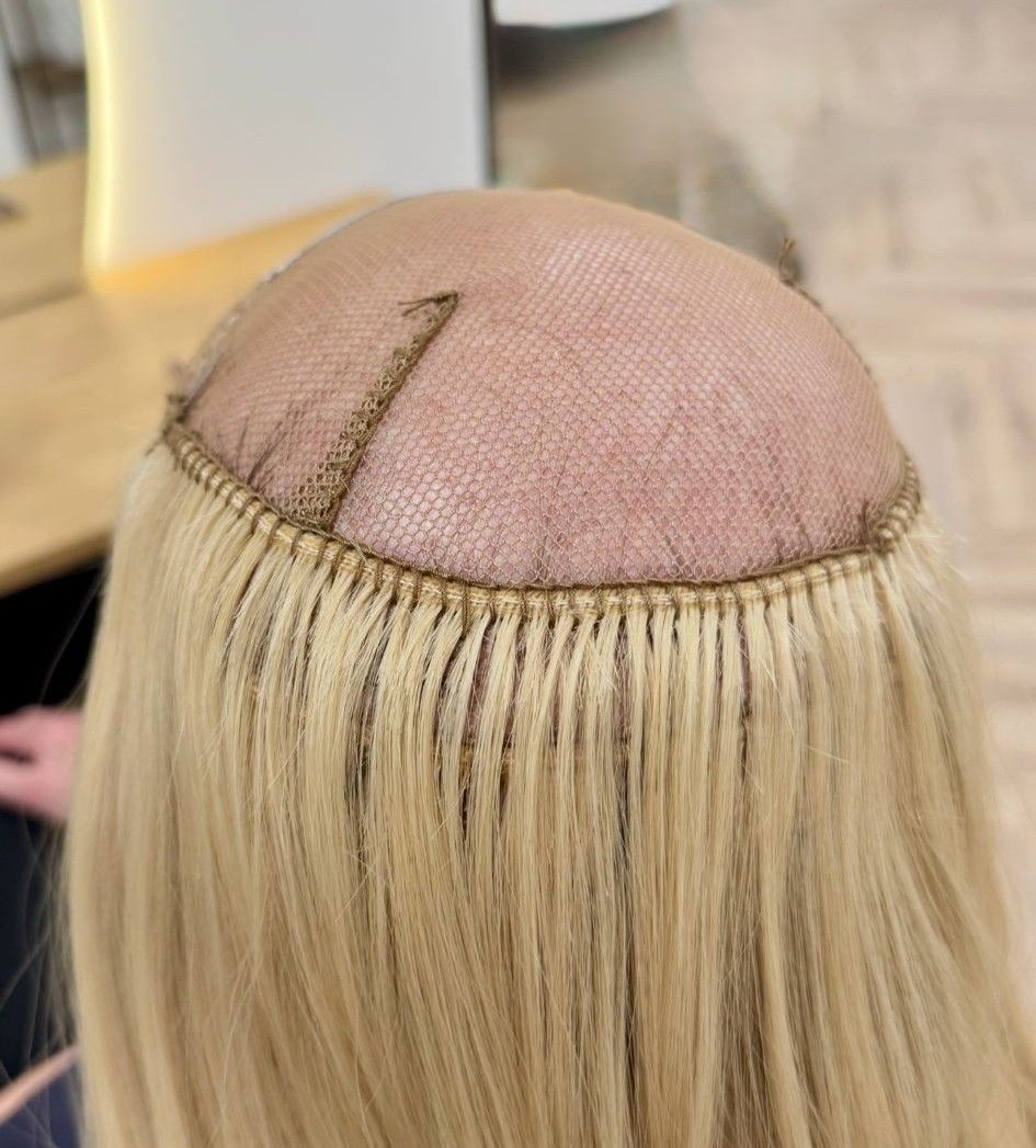 Mesh system being integrated with woman's remaining hair after hair loss